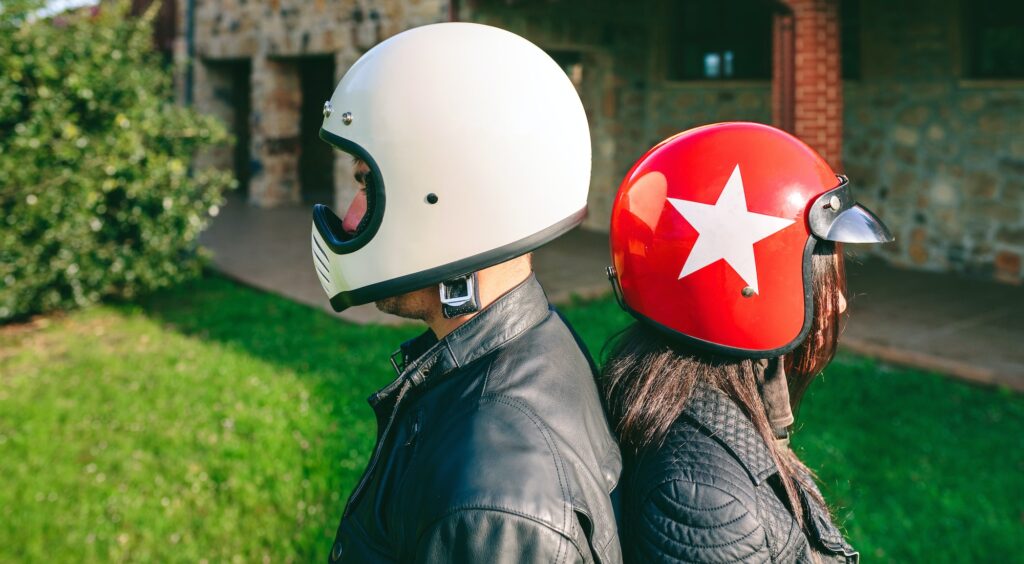 Couple posing with motorcycle helmets